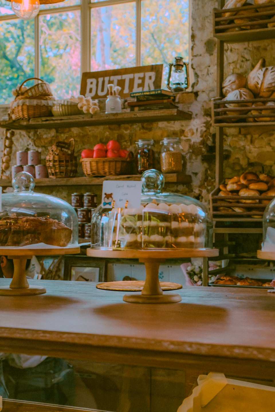 Bakery counter with fresh baked goods displayed under glass.